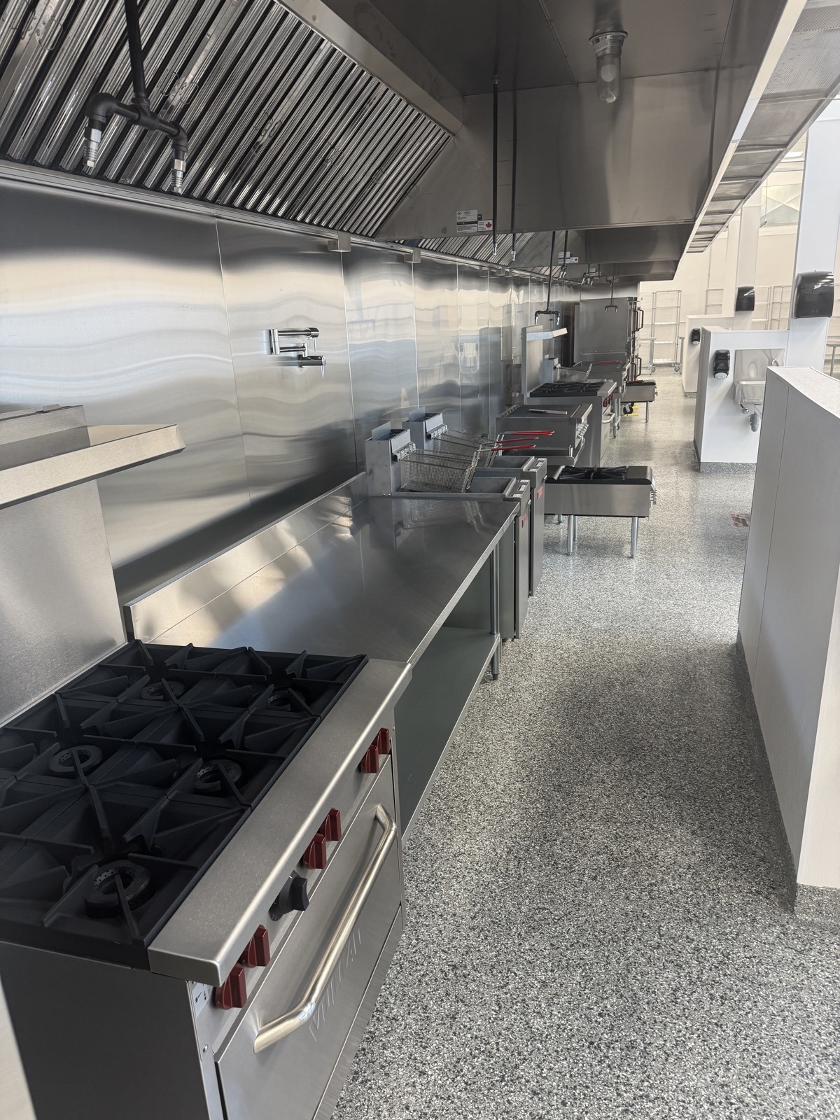 Gas ranges and flat top grills on the 100 foot commercial cookline