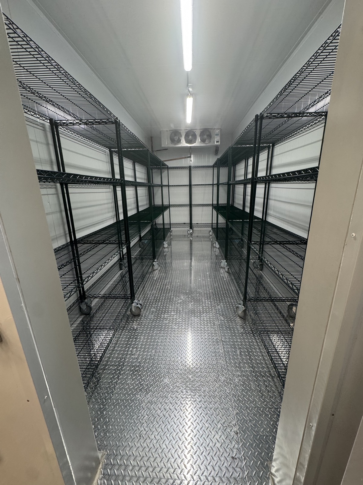 Walk-in cooler with dedicated member storage shelving