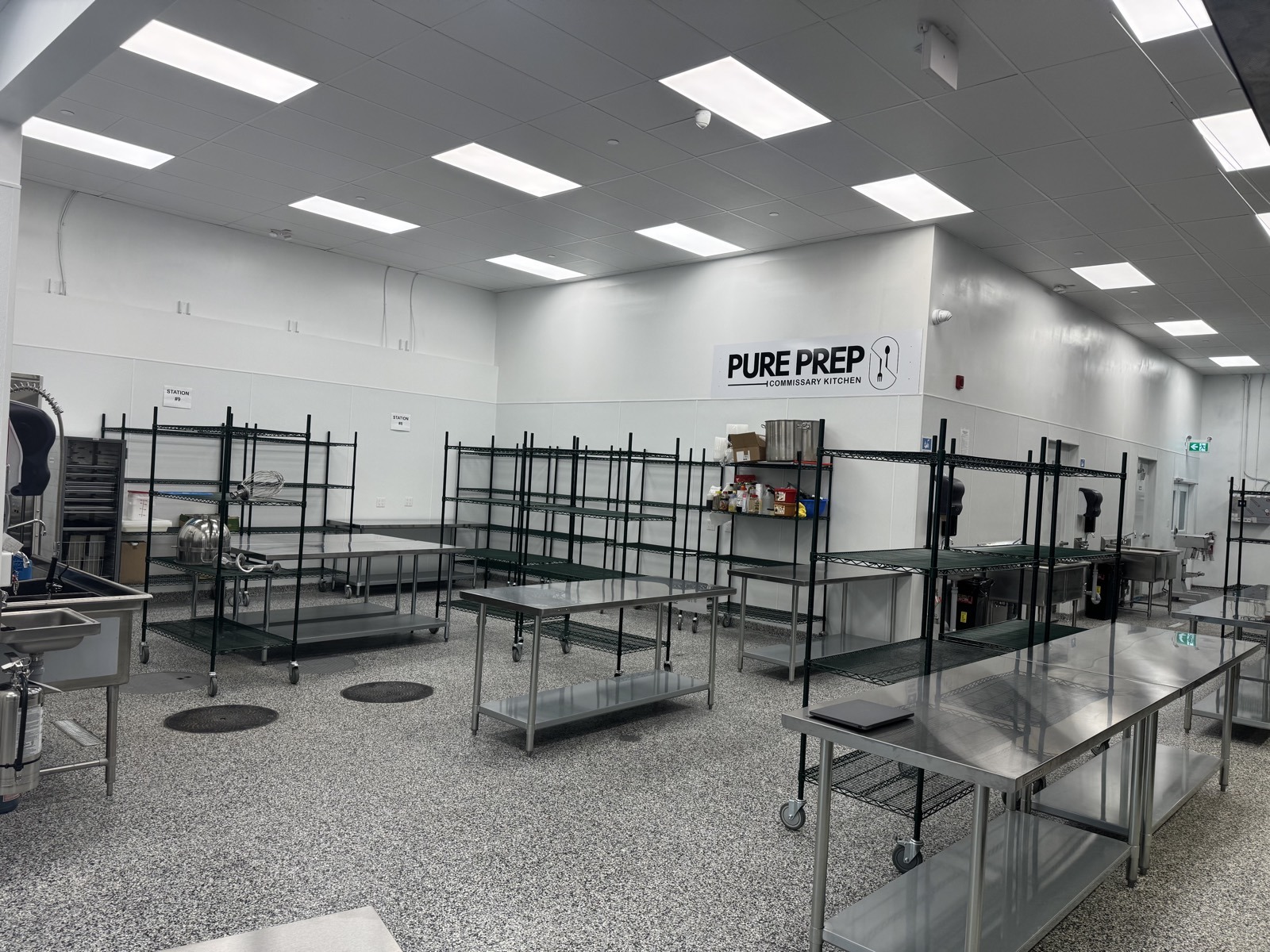 PurePrep branded production space with prep tables and storage racks near Victoria