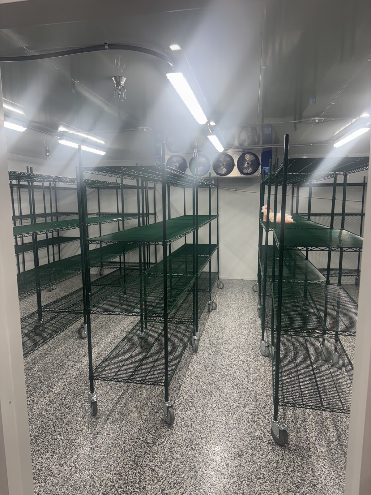 Walk-in cooler with member storage shelving