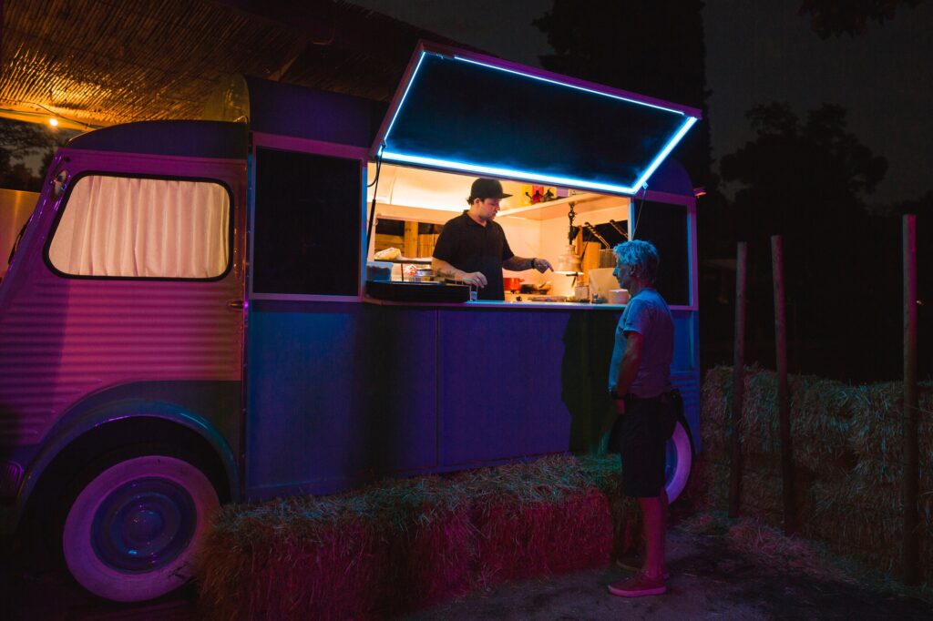 Cook serving a customer in his food truck